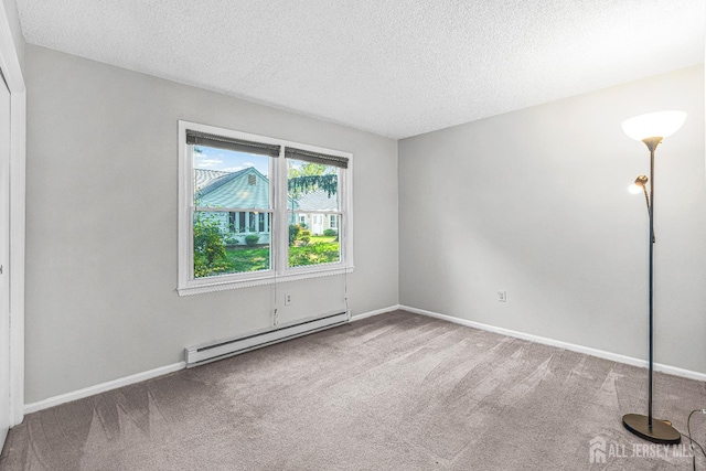 298-B Sharon Way, Monroe, NJ 08831 - carpeted empty room with baseboard heating and a textured ceiling