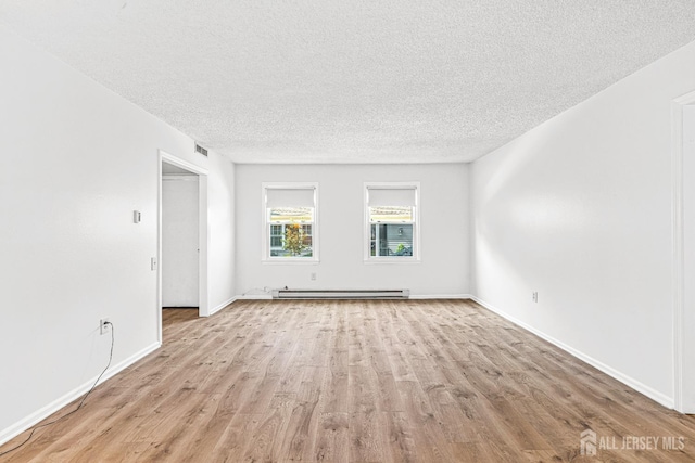 298-B Sharon Way, Monroe, NJ 08831 - spare room with a baseboard heating unit, a textured ceiling, and light wood-style floors