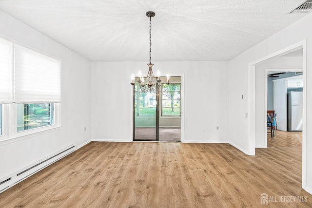 298-B Sharon Way, Monroe, NJ 08831 - unfurnished dining area featuring baseboard heating, a chandelier, plenty of natural light, and light wood-style floors