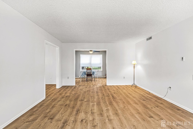 298-B Sharon Way, Monroe, NJ 08831 - empty room featuring wood finished floors, a textured ceiling, and baseboard heating