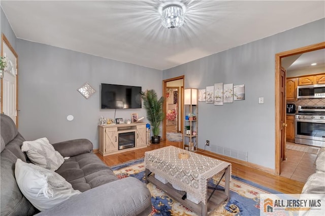 living room with light hardwood / wood-style flooring