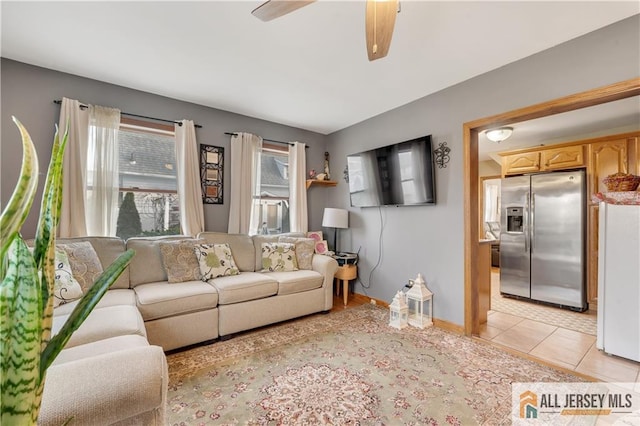 tiled living room featuring ceiling fan