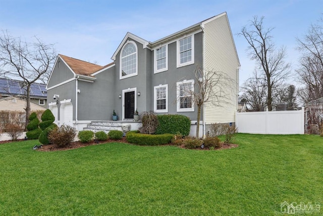 view of front facade featuring a garage and a front yard