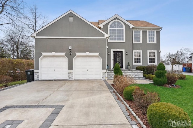 view of front of home with a garage and a front lawn