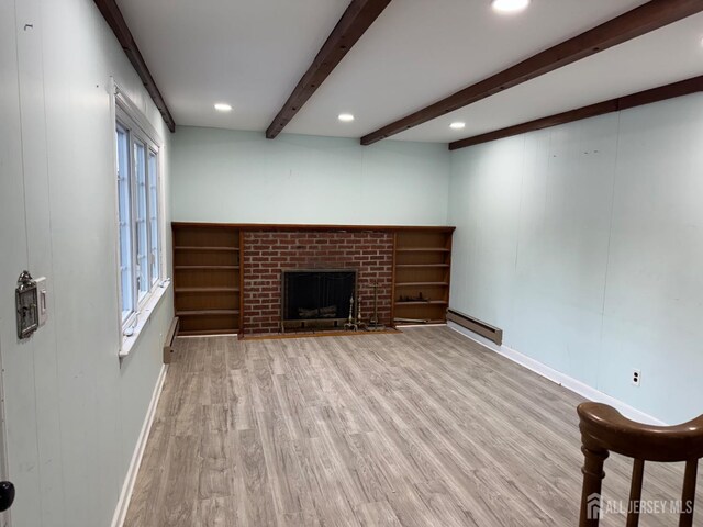 unfurnished living room featuring a fireplace, a baseboard radiator, beamed ceiling, and light wood-type flooring