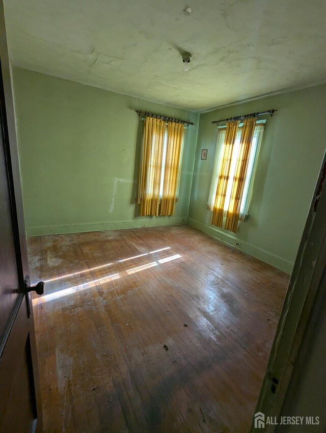 spare room featuring hardwood / wood-style flooring