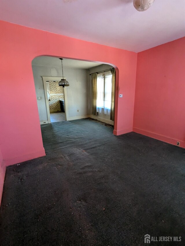 empty room featuring dark colored carpet