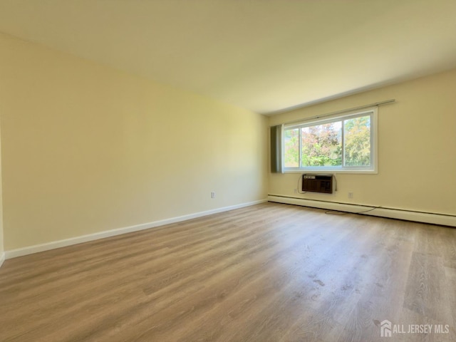 9 Lake Ave Unit 4A, East Brunswick, NJ 08816 - spare room featuring wood finished floors, baseboard heating, and an AC wall unit