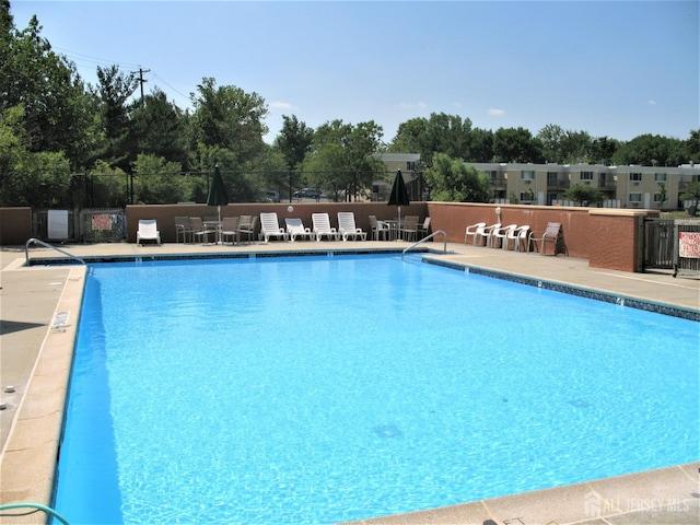 9 Lake Ave Unit 4A, East Brunswick, NJ 08816 - community pool featuring a patio area and view of scattered trees