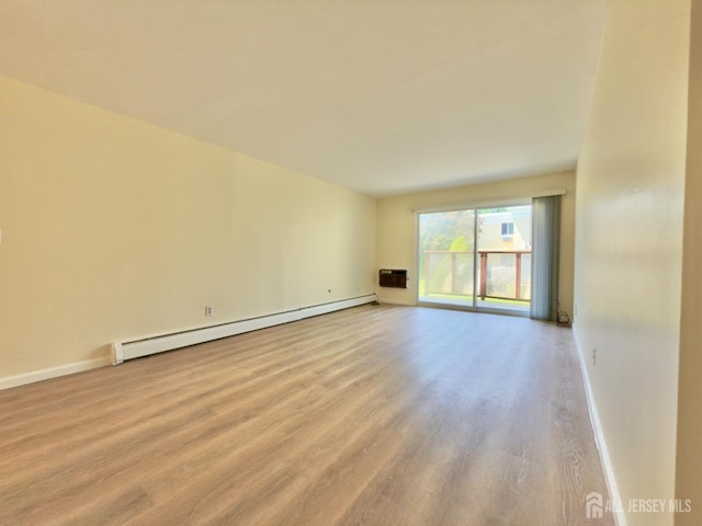 9 Lake Ave Unit 4A, East Brunswick, NJ 08816 - empty room with a baseboard radiator, wood finished floors, and a wall unit AC