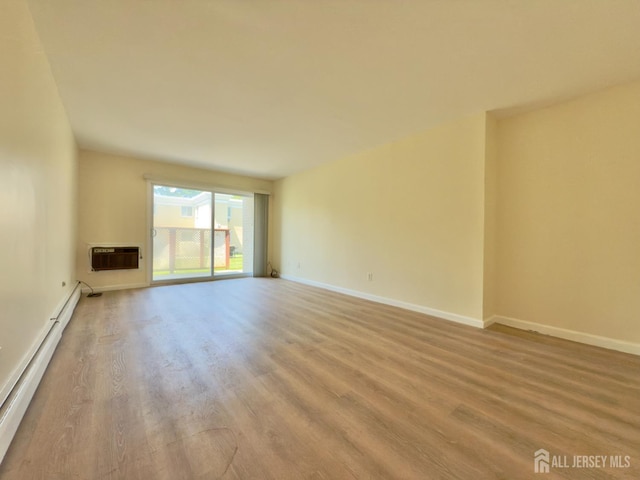 9 Lake Ave Unit 4A, East Brunswick, NJ 08816 - unfurnished room featuring baseboard heating, wood finished floors, and a wall mounted AC