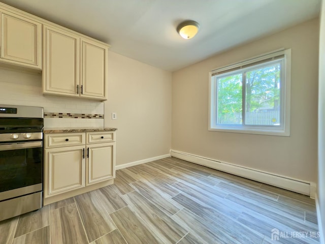 9 Lake Ave Unit 4A, East Brunswick, NJ 08816 - kitchen with stainless steel stove, baseboard heating, backsplash, light wood-style floors, and light stone counters
