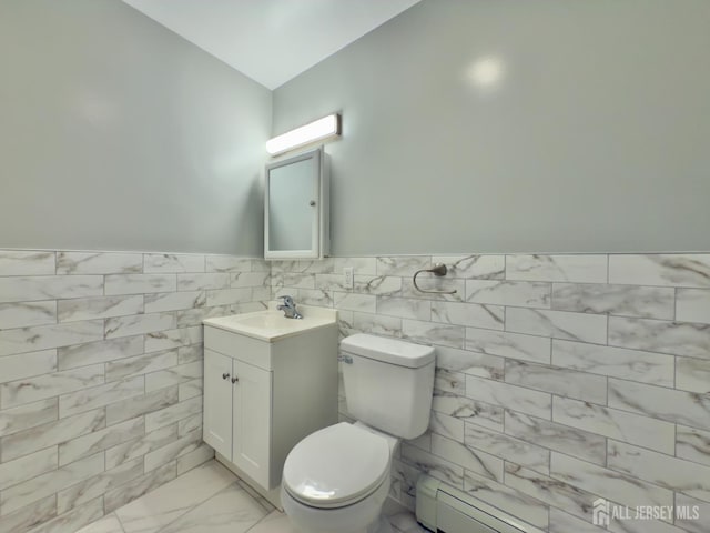 9 Lake Ave Unit 4A, East Brunswick, NJ 08816 - half bathroom featuring vanity, tile walls, lofted ceiling, marble finish floors, and a wainscoted wall