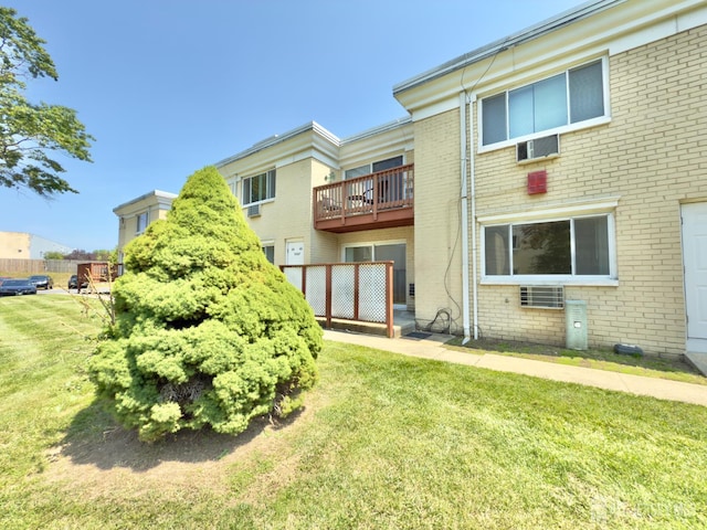 9 Lake Ave Unit 4A, East Brunswick, NJ 08816 - back of property with brick siding, a balcony, and a lawn