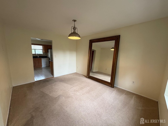 4 La Valencia Rd, Old Bridge, NJ 08857 - spare room with light colored carpet, a sink, and baseboards