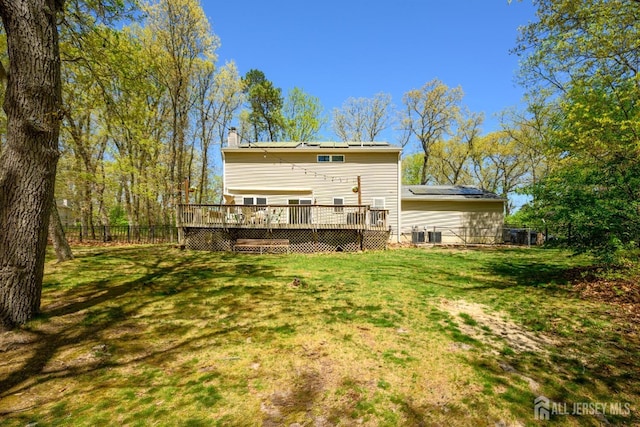 2-A Lake Ave, Helmetta, NJ 08828 - back of property featuring a deck, solar panels, and a chimney
