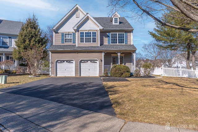 view of front of home with a front lawn, driveway, fence, covered porch, and an attached garage