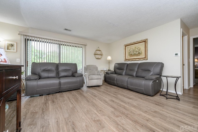3002 Lighthouse Ln, Sayreville, NJ 08859 - living room featuring a textured ceiling and wood finished floors