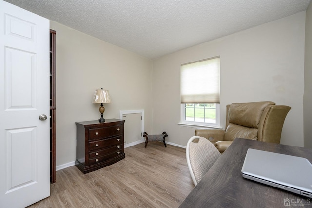 3002 Lighthouse Ln, Sayreville, NJ 08859 - sitting room featuring light wood-style floors, baseboards, and a textured ceiling