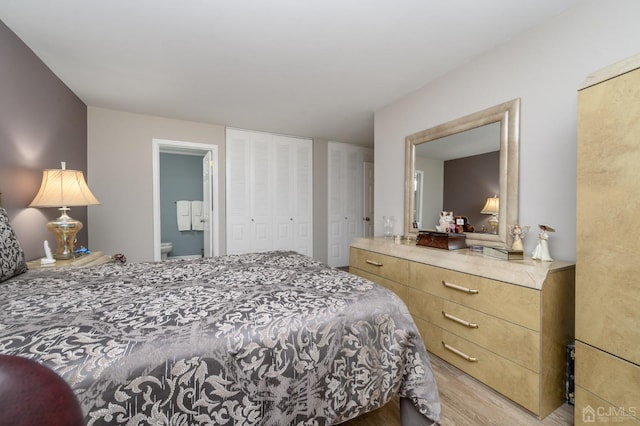 3002 Lighthouse Ln, Sayreville, NJ 08859 - bedroom featuring light wood-style floors, multiple closets, and ensuite bath