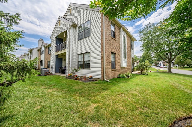 3002 Lighthouse Ln, Sayreville, NJ 08859 - back of house with a lawn, brick siding, central AC unit, and a balcony
