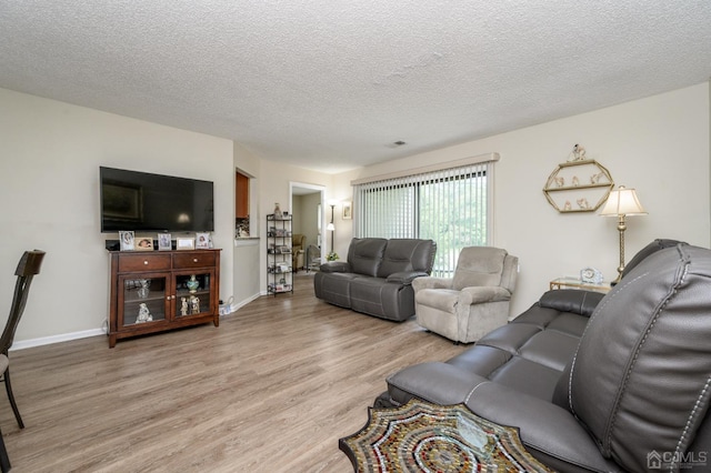 3002 Lighthouse Ln, Sayreville, NJ 08859 - living area with light wood-style flooring, a textured ceiling, and baseboards