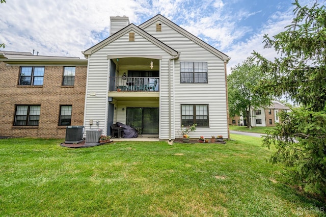 3002 Lighthouse Ln, Sayreville, NJ 08859 - rear view of house featuring a balcony, a chimney, cooling unit, and a lawn