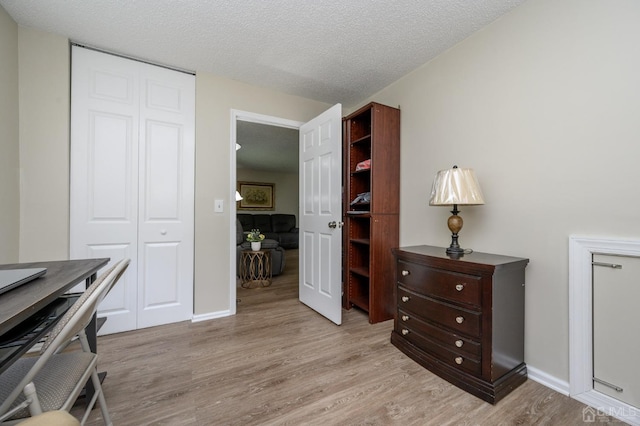 3002 Lighthouse Ln, Sayreville, NJ 08859 - home office with light wood finished floors, a textured ceiling, and baseboards
