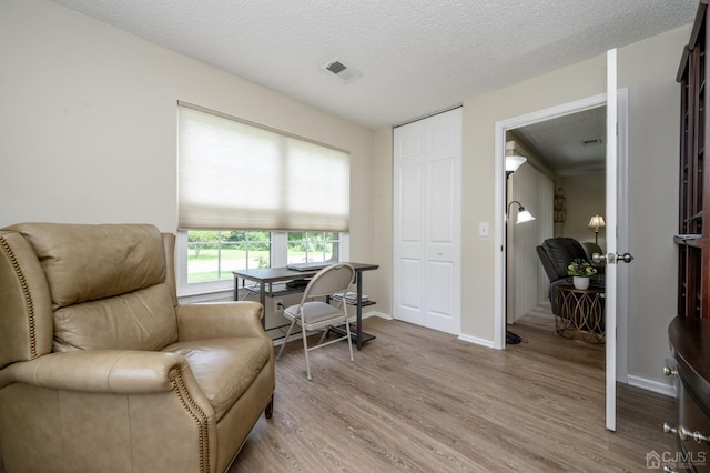 3002 Lighthouse Ln, Sayreville, NJ 08859 - living area featuring light wood finished floors, baseboards, and a textured ceiling