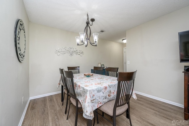 3002 Lighthouse Ln, Sayreville, NJ 08859 - dining space with wood finished floors, a chandelier, and baseboards