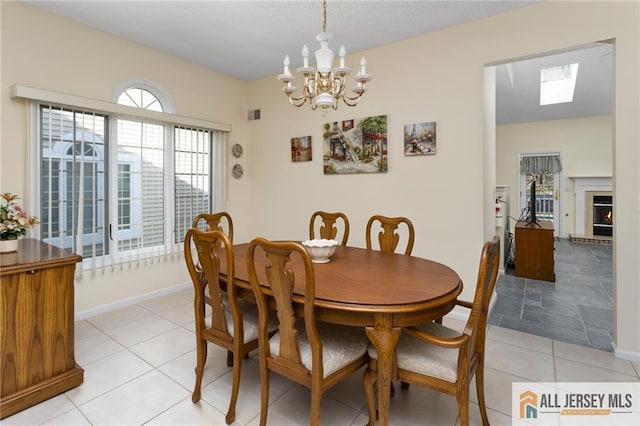 31 Cameron Ct, Monroe, NJ 08831 - dining space featuring light tile patterned floors, a chandelier, a skylight, and baseboards