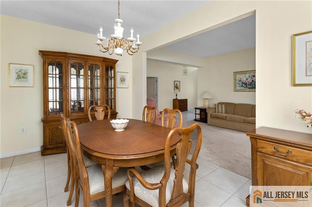31 Cameron Ct, Monroe, NJ 08831 - dining area with a chandelier, light tile patterned flooring, light colored carpet, and baseboards
