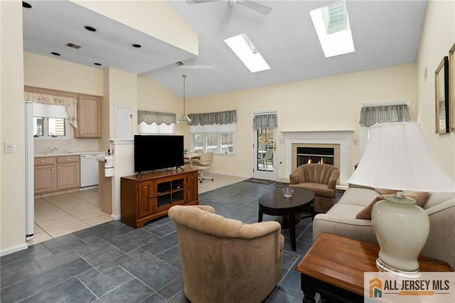 31 Cameron Ct, Monroe, NJ 08831 - living area with lofted ceiling, a ceiling fan, plenty of natural light, a lit fireplace, and a skylight
