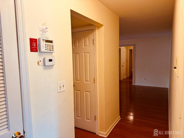 404 Newport Ct, Fords, NJ 08863 - corridor featuring dark wood-type flooring and baseboards
