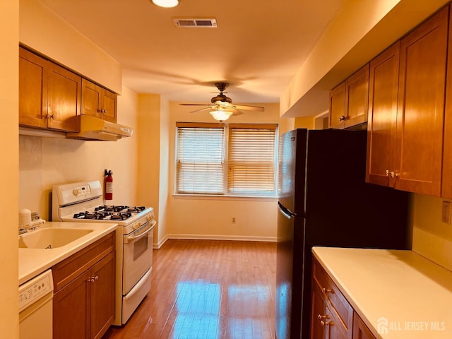 404 Newport Ct, Fords, NJ 08863 - kitchen featuring white appliances, premium range hood, ceiling fan, and brown cabinetry