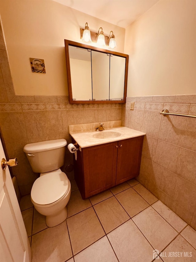 404 Newport Ct, Fords, NJ 08863 - half bath featuring tile walls, vanity, toilet, wainscoting, and tile patterned floors
