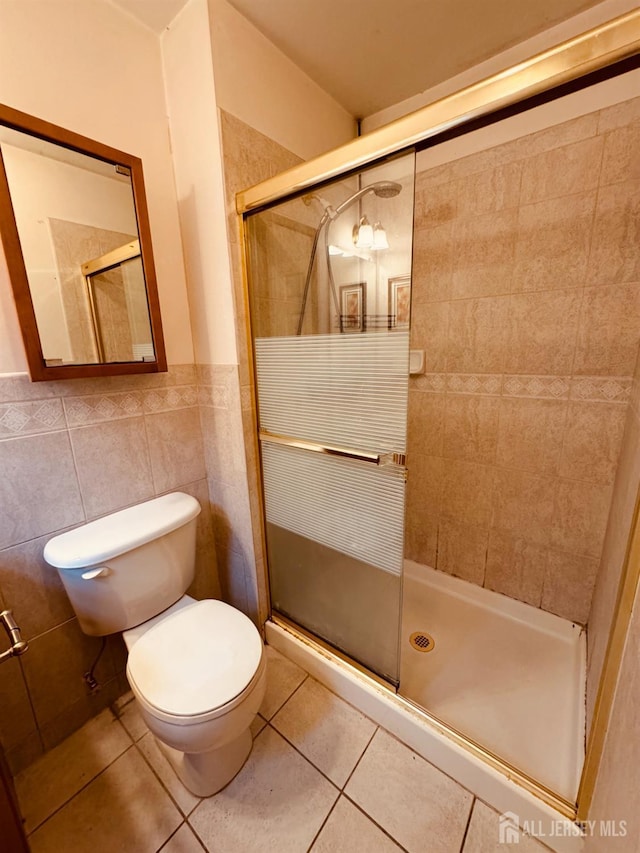 404 Newport Ct, Fords, NJ 08863 - bathroom featuring toilet, a shower stall, tile patterned floors, tile walls, and a wainscoted wall