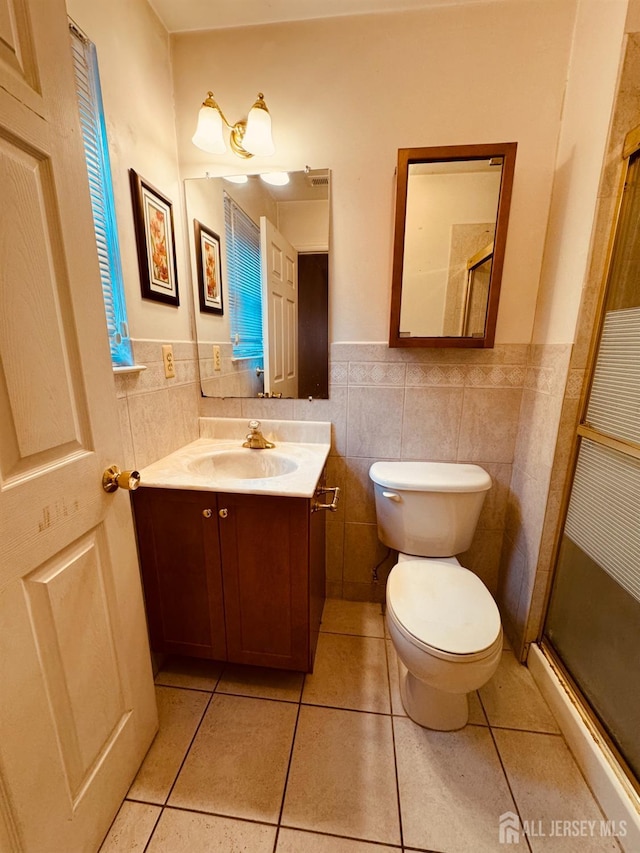 404 Newport Ct, Fords, NJ 08863 - full bathroom featuring toilet, tile walls, wainscoting, tile patterned flooring, and vanity