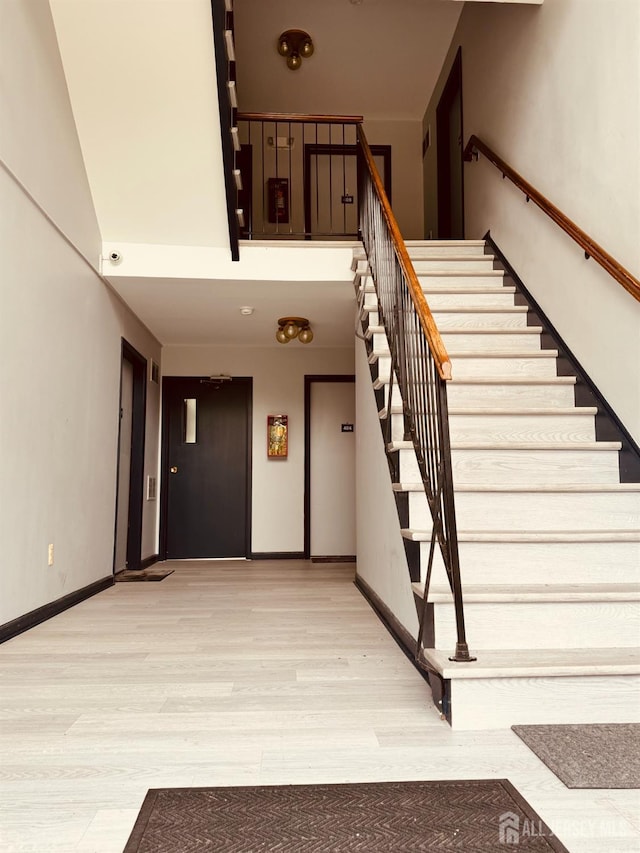404 Newport Ct, Fords, NJ 08863 - stairs featuring wood finished floors and baseboards