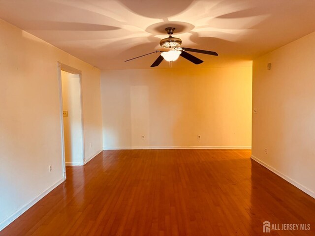 404 Newport Ct, Fords, NJ 08863 - unfurnished room with wood finished floors, a ceiling fan, and baseboards