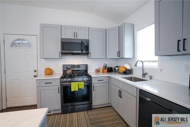 3060 Bordentown Ave, Old Bridge, NJ 08859 - kitchen with stainless steel microwave, gas stove, a sink, gray cabinetry, and black dishwasher