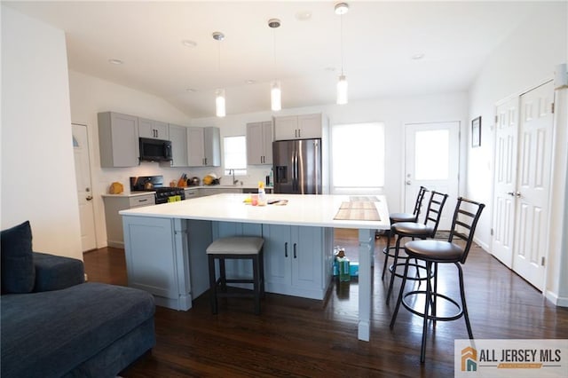 3060 Bordentown Ave, Old Bridge, NJ 08859 - kitchen with black appliances, gray cabinets, a kitchen bar, a sink, and dark wood-style flooring