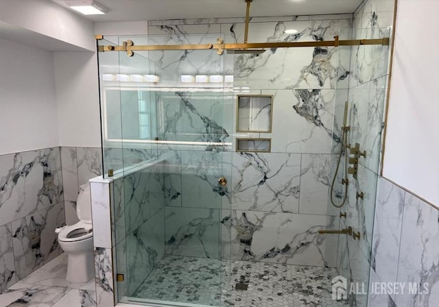 bathroom with toilet, marble finish floor, and a marble finish shower