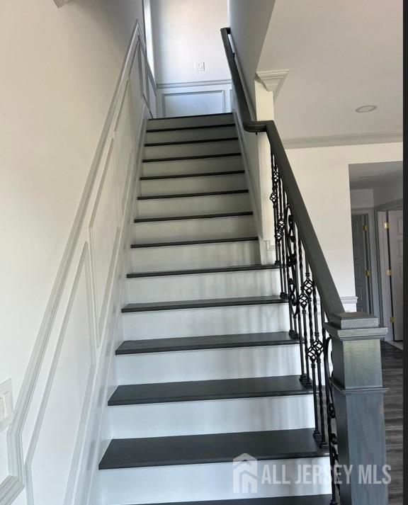 stairs featuring wood finished floors