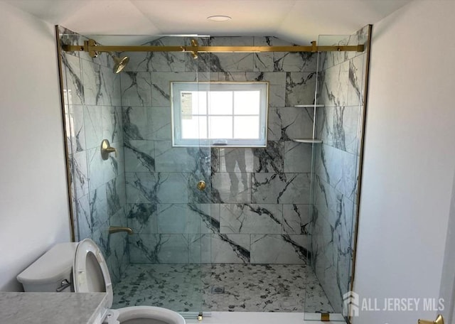 full bathroom featuring vanity, lofted ceiling, toilet, and a marble finish shower