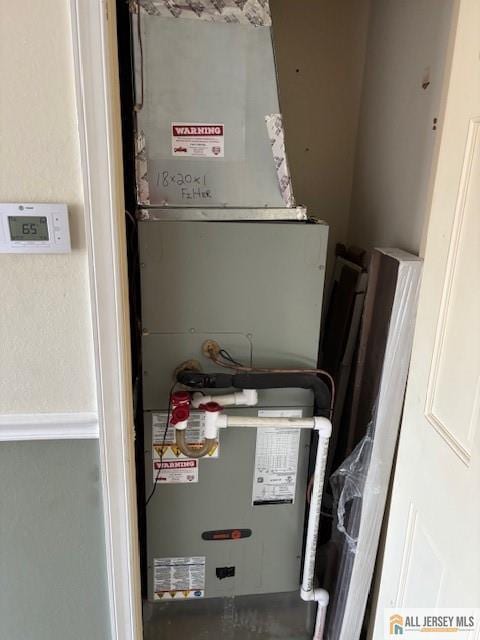 utility room featuring heating unit