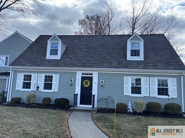 new england style home with a front yard