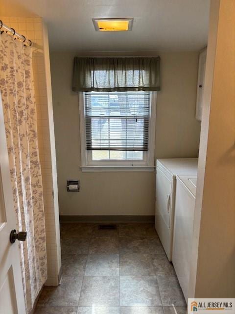 clothes washing area featuring washer and dryer