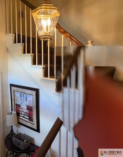 stairs with a chandelier