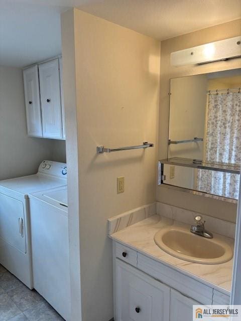 bathroom featuring separate washer and dryer and vanity